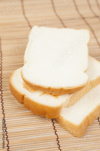 Sliced ​​bread on the wooden plate.