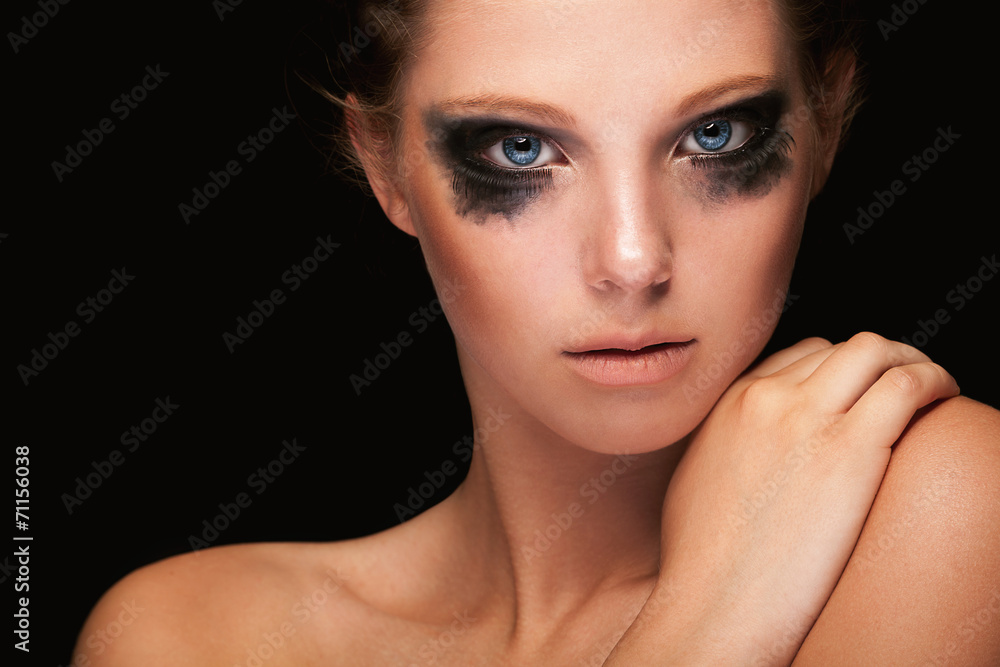 Fototapeta premium Fashion girl crying make up on black
