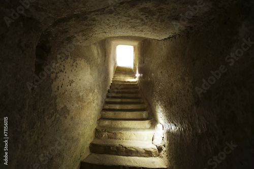 stone narrow passage with stairs leading