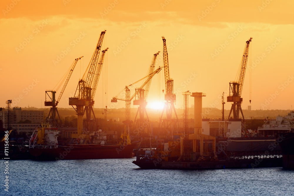 Ships and cranes on sunset