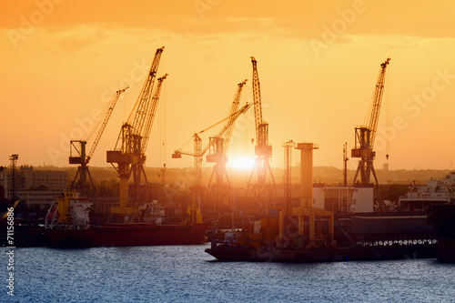Ships and cranes on sunset