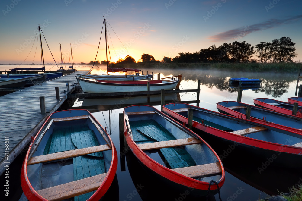 Fototapeta premium boats and yachts on lake at sunrise