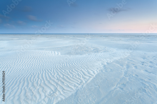 sand dunes on North sea coast during sunrise