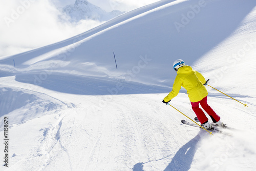 Skiing, skier, winter sport - woman skiing downhill