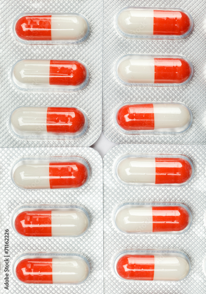 Pack of red pills, isolated. Healthcare concept. Pack of red pills, isolated. Healthcare concept.