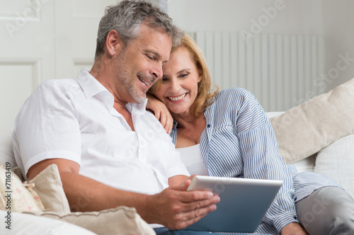 Happy Mature Couple With Tablet
