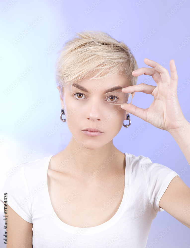 Optics and Glasses, Portrait of young smiling woman looking thro Optics and Glasses, Portrait of young smiling woman looking thro