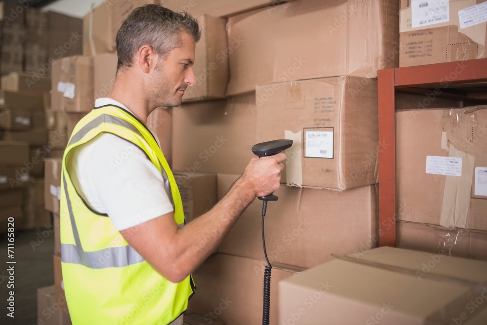 Worker scanning package in warehouse Worker scanning package in warehouse