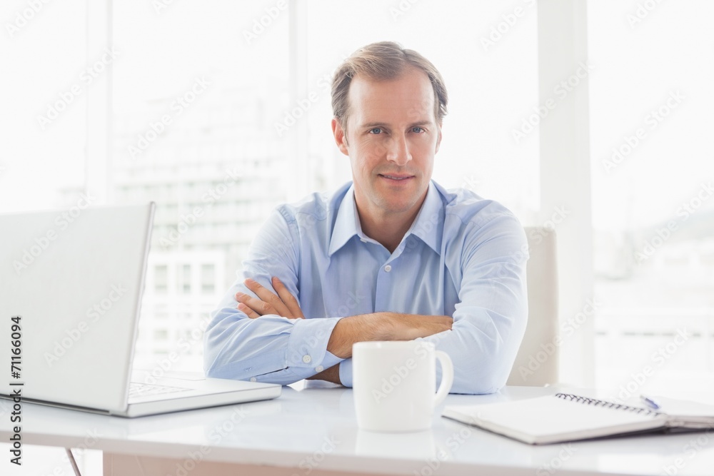 Relaxed businessman smiling at camera Relaxed businessman smiling at camera