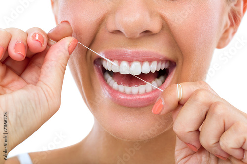 woman flossing her teeth photo