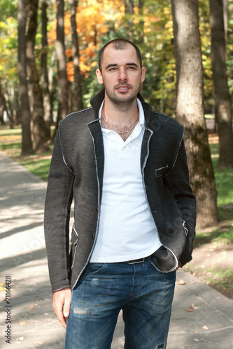 A man stands with his hands in his pockets