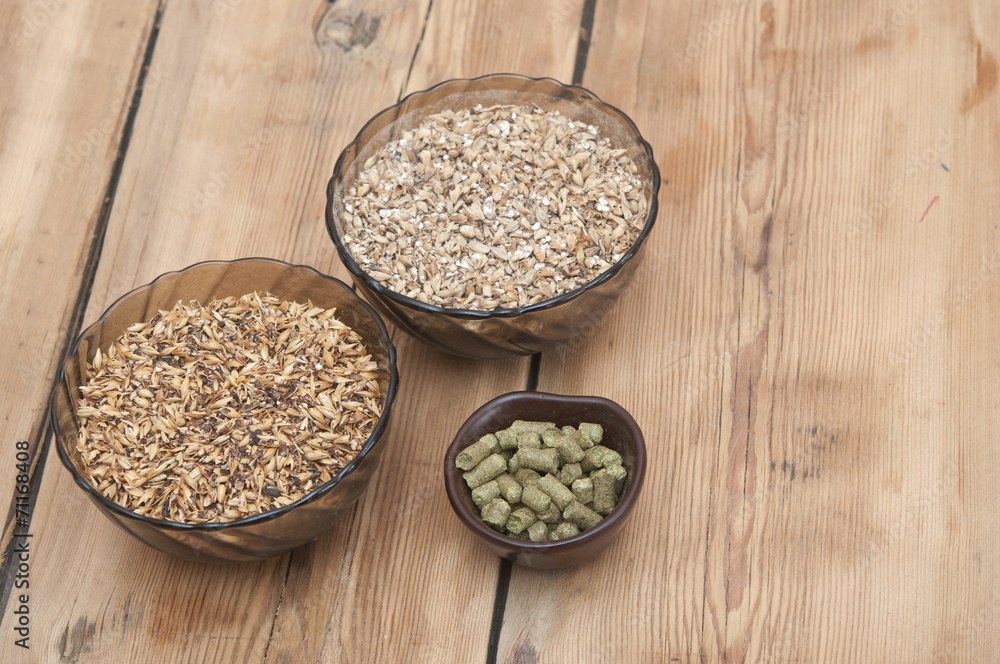 beer ingredients, hops and malt on wooden table top beer ingredients, hops and malt on wooden table top