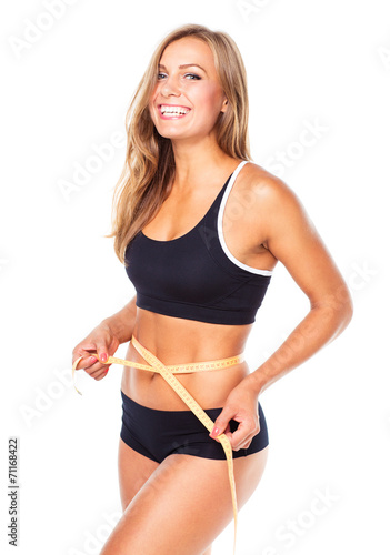 Portrait of attractive caucasian smiling woman with measuring ta