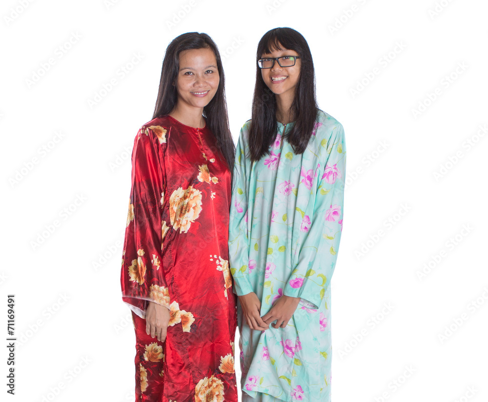 Asian Malay mother and daughter in traditional dress Asian Malay mother and daughter in traditional dress
