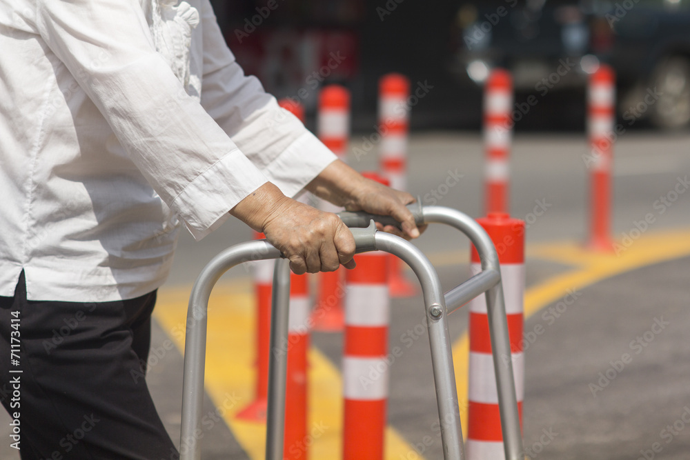 Senior woman using a walker cross street. Senior woman using a walker cross street.