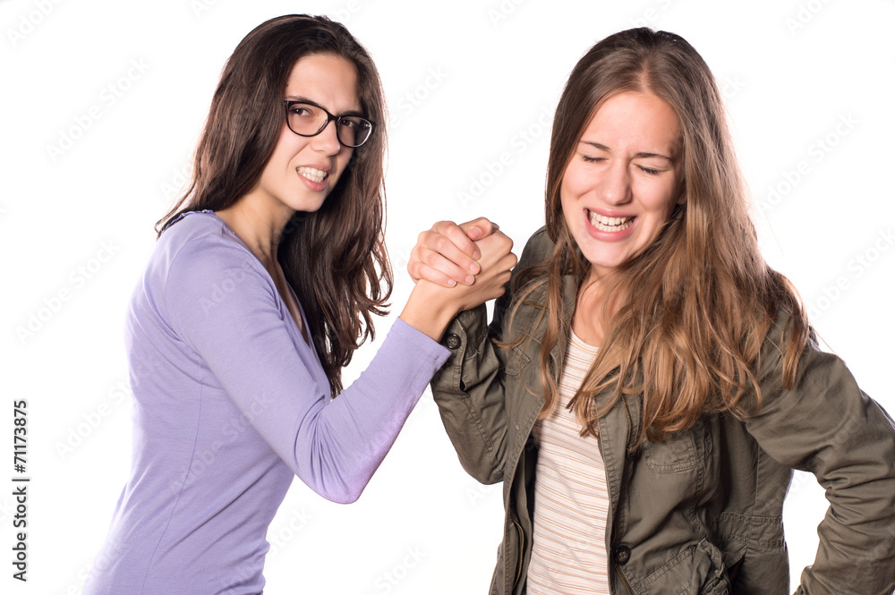 Two Young Girls Arm Wrestling and smiling Two Young Girls Arm Wrestling and smiling