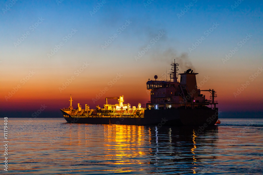 Ship swims on the sea at night.