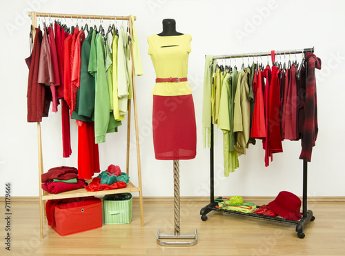 Dressing closet with complementary colors red and green clothes.