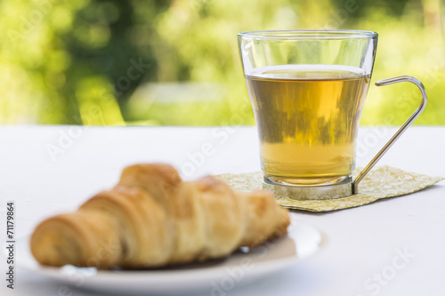 Croissant and hot Tea in garden