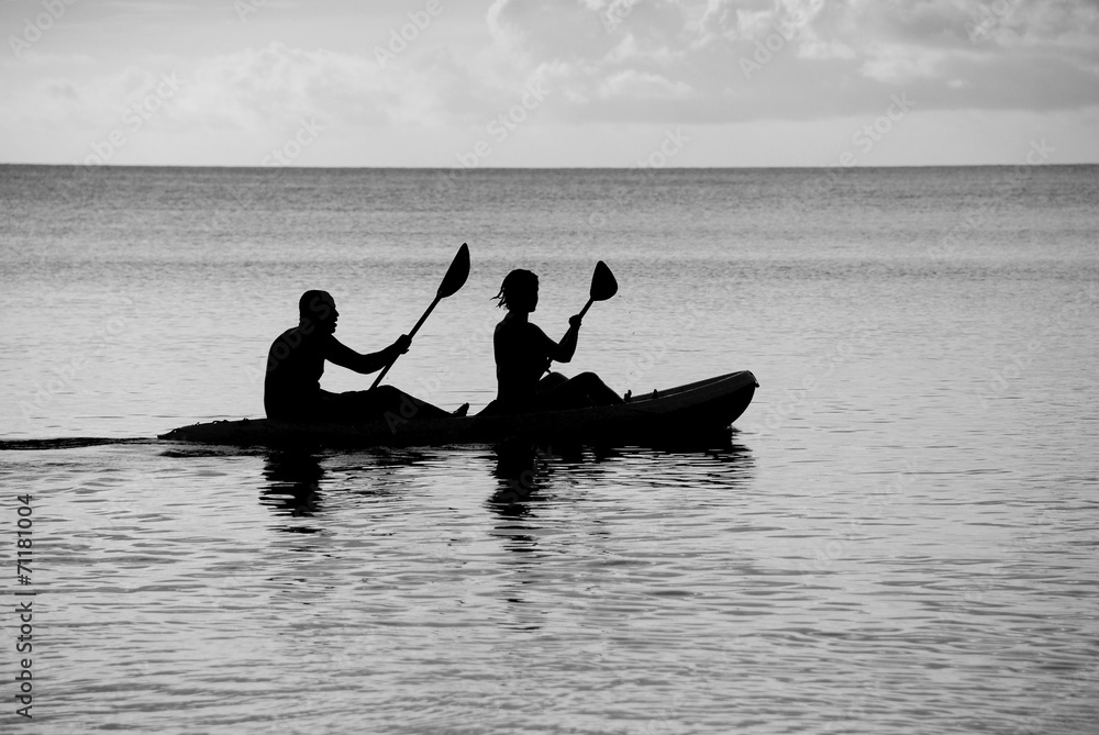 Kayakers silhouetted on the ocean