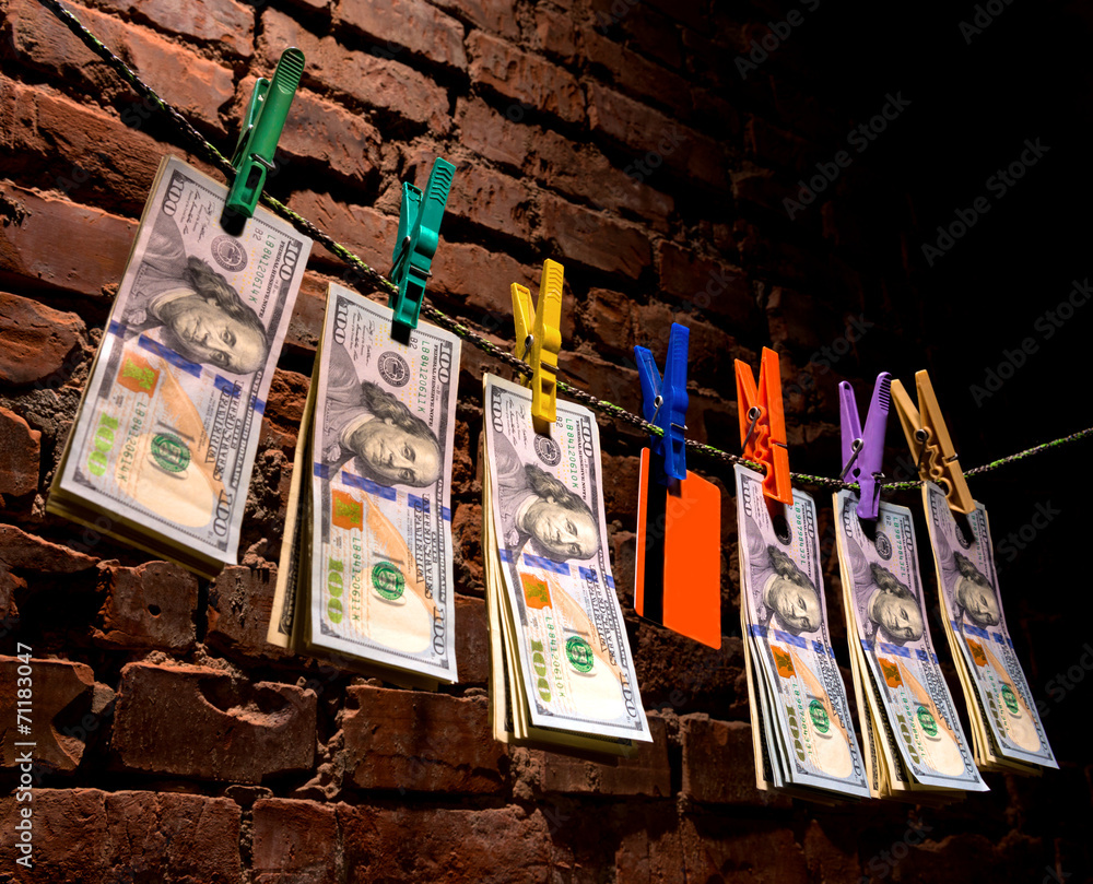 Dollar bills and credit card hanging on a rope