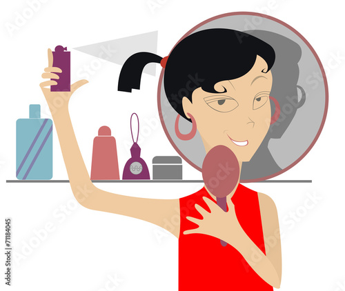 The girl looks in the mirror and uses cosmetics