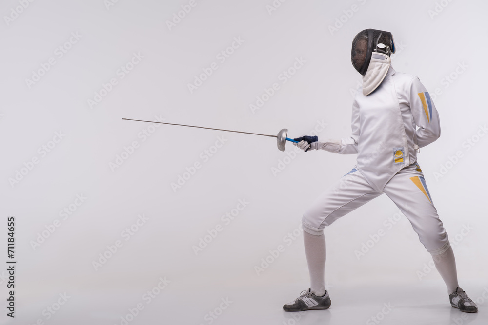 Young woman engaging in fencing Young woman engaging in fencing