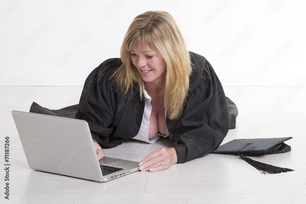 Mature university student studying on a laptop computer Mature university student studying on a laptop computer