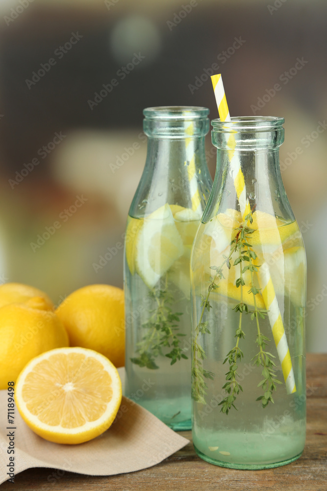 Fototapeta premium Tasty cool beverage with lemon and thyme, on light background