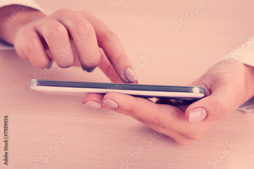 Woman using smartphone on light background
