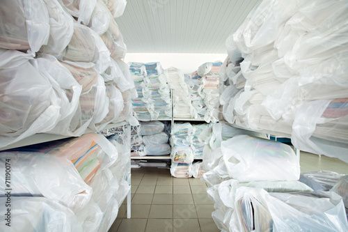 Image of racks with clean clothes in laundry room