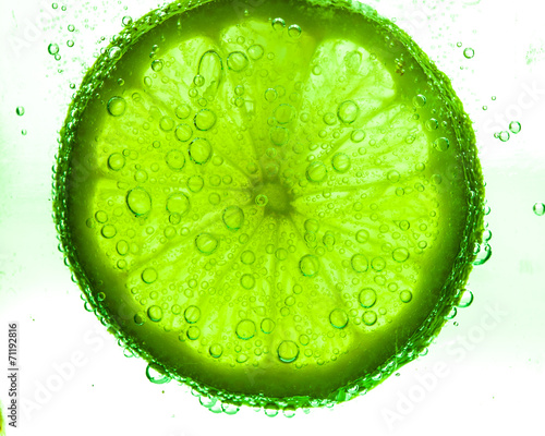 Slice of lime with water drops