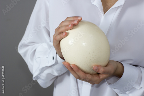 Woman with ostrich egg in her hands