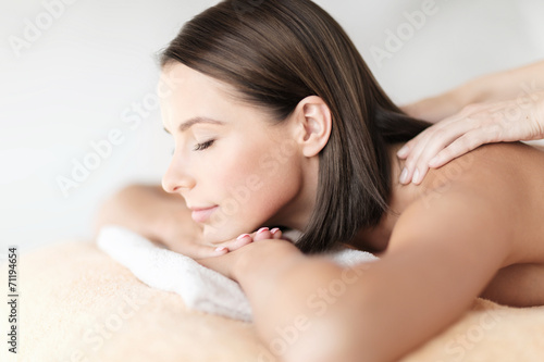 beautiful woman in spa salon getting massage