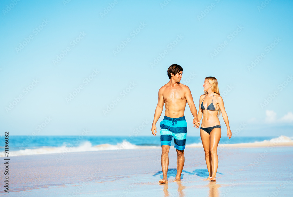 Attractive Couple Walking on Tropical Beach