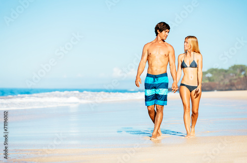 Attractive Couple Walking on Tropical Beach