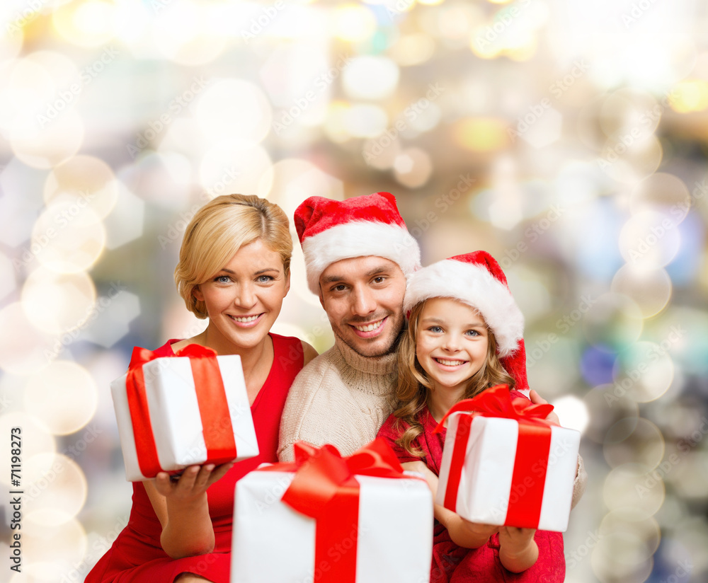 happy family in santa helper hats with gift boxes happy family in santa helper hats with gift boxes