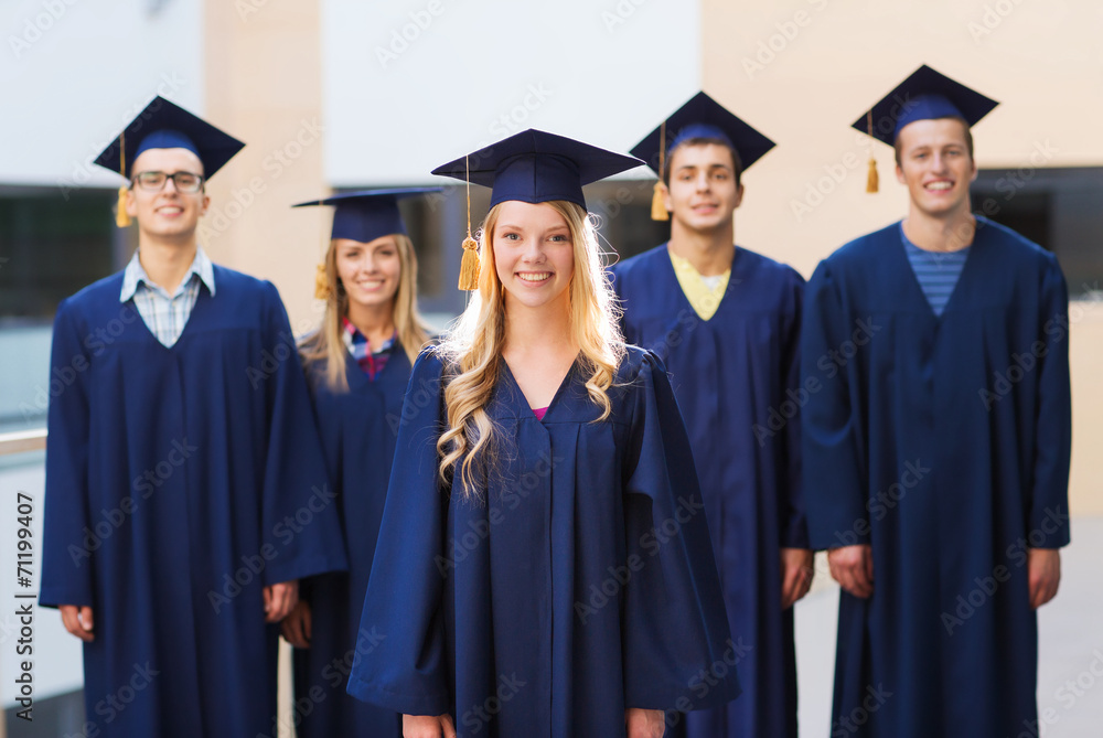 group of smiling students in mortarboards group of smiling students in mortarboards