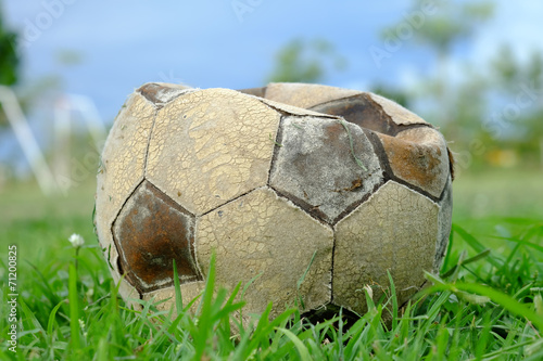 old deflated soccer ball, old deflated football on the groud photo