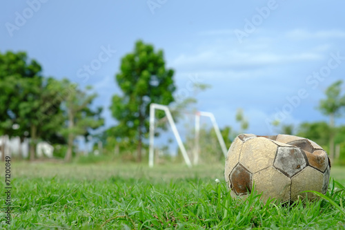 old deflated soccer ball, old deflated football on the groud