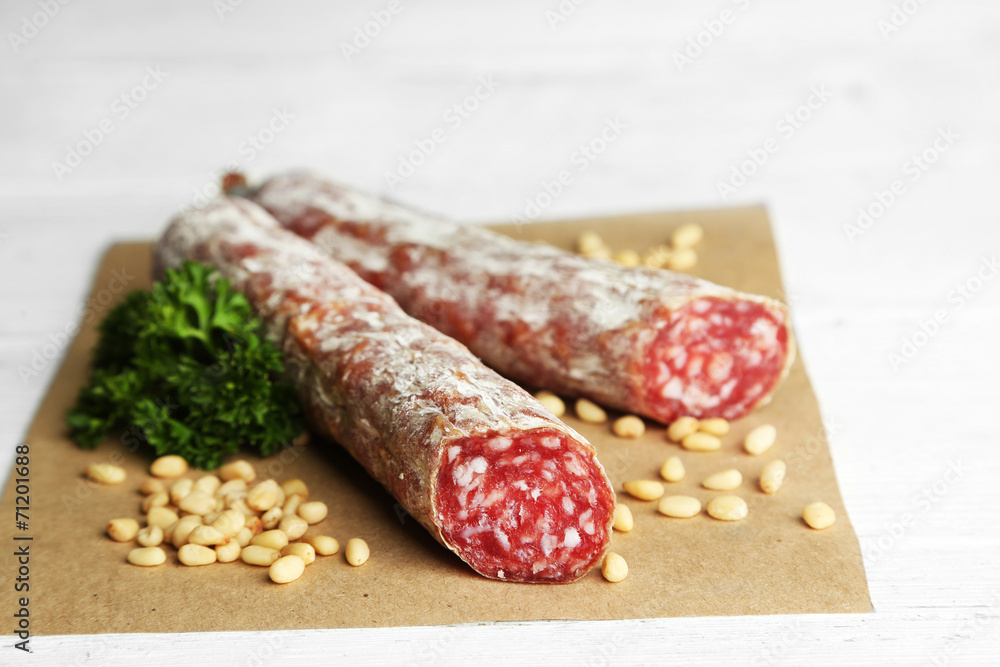Italian salami on wooden background Italian salami on wooden background