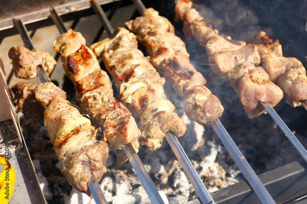 Skewers on barbecue grill, close-up