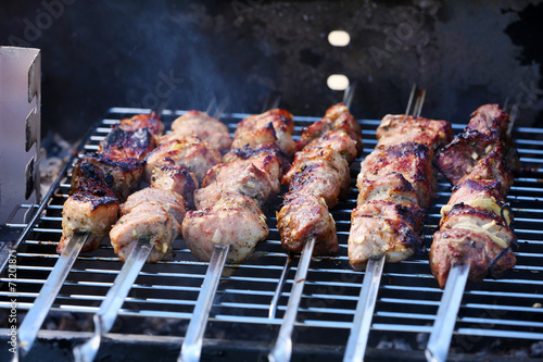 Skewers on barbecue grill, close-up