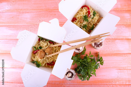 Chinese noodles with meat and pepper in takeaway boxes