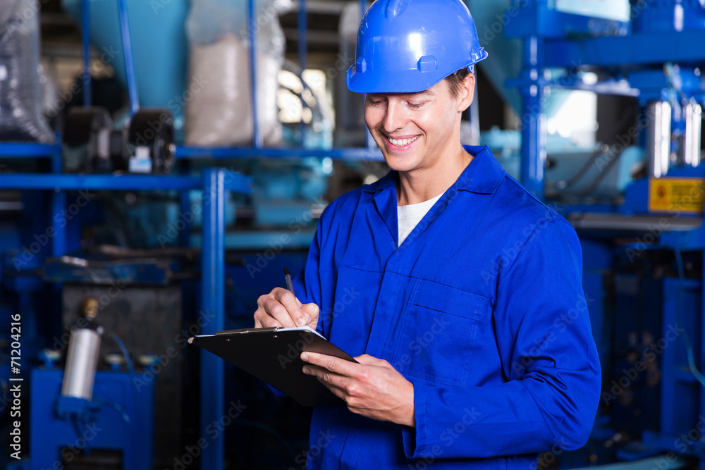 factory worker writing report factory worker writing report