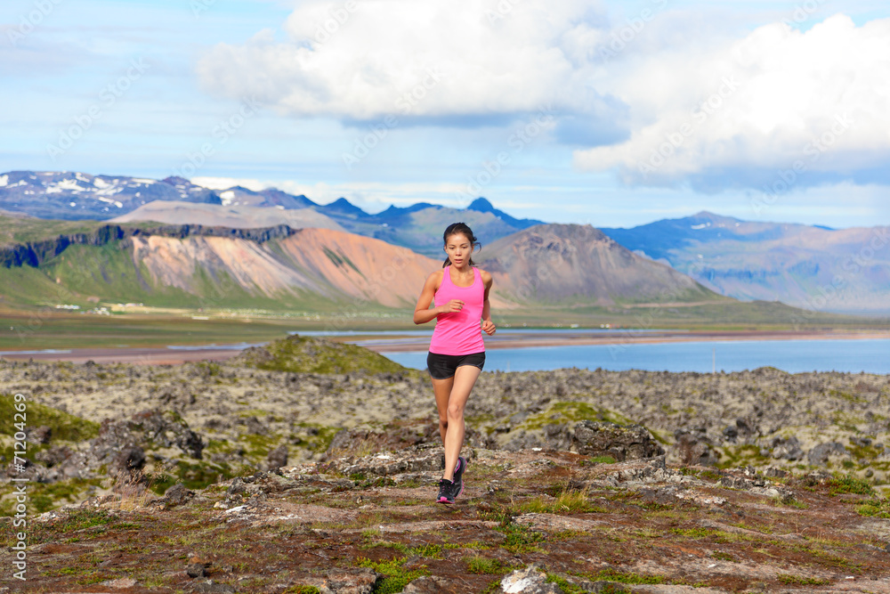 Runner woman trail running in nature