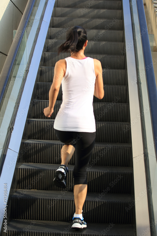 Runner athlete running on escalator stairs. Runner athlete running on escalator stairs.