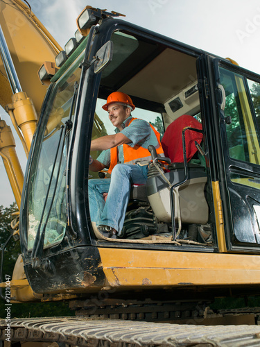 Foto male worker operating excavator