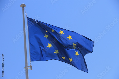 European flag with twelve yellow stars on blue sky