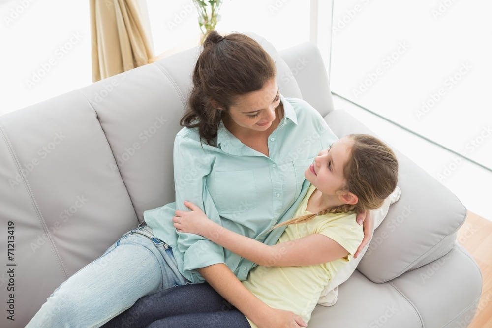 Cute mother and daughter on the couch Cute mother and daughter on the couch